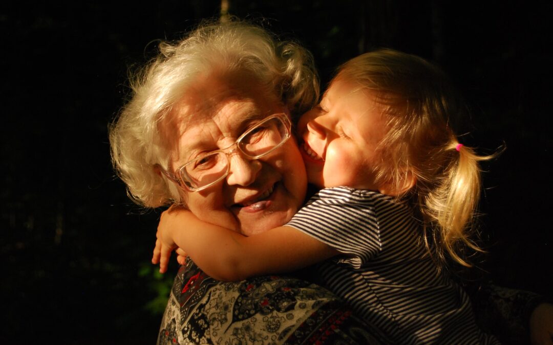 woman in black and white striped shirt hugging girl in black and white striped shirt